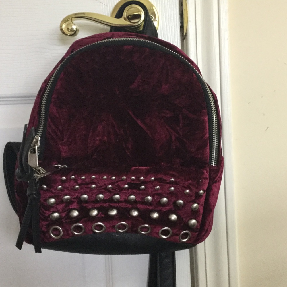 A cute burgundy mini backpack